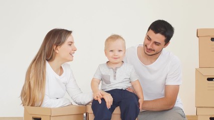 Family, parents and son, unpacking boxes and moving into new home, baby help for parents