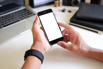 Cropped shot view of man hands holding smart phone with blank copy space screen for your text message or information content, female reading text message on cell telephone during in urban setting. 