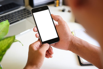 Cropped shot view of man hands holding smart phone with blank copy space screen for your text message or information content, female reading text message on cell telephone during in urban setting. 