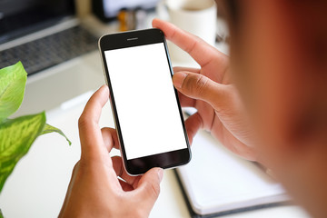Cropped shot view of man hands holding smart phone with blank copy space screen for your text message or information content, female reading text message on cell telephone during in urban setting. 