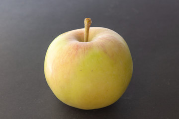 Apple plucked from a tree on a black background