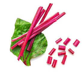 Creative layout made of Fresh Rhubarb or Rheum with stalks, leaves  and pieces  vegetable isolated...