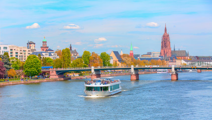 Fototapeta premium Cityscape with cruise ship sailing in the river, Frankfurt am main, Germany