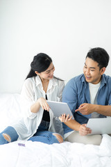 Surprising Asian couple using laptop at home, lifestyle concept.