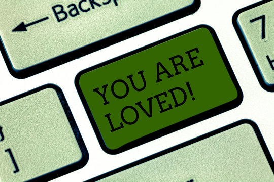 Text sign showing You Are Loved. Conceptual photo Somebody loves you have strong feelings happy excited Keyboard key Intention to create computer message pressing keypad idea