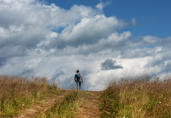 Fantastic starry night with galaxy Milky Way with a tourist and a tent on the mountain range in the Ukrainian Carpathians	