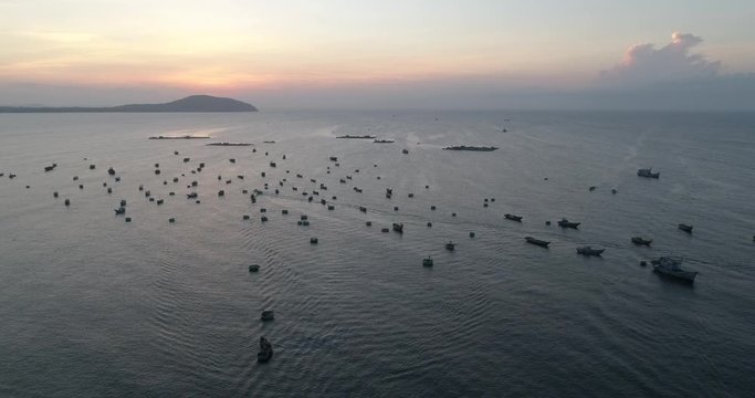 Top view, aerial view fishing harbor market from a drone. Royalty high-quality free stock video footage of market at Mui Ne fishing harbour or fishing village. Fishing harbor is a popular tourist