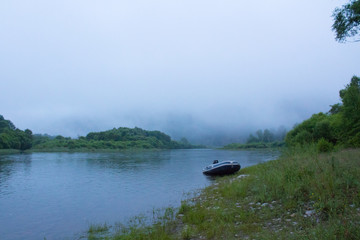 Obraz na płótnie Canvas foggy river, boat in the fog, boat by the river, cold landscape, Siberia
