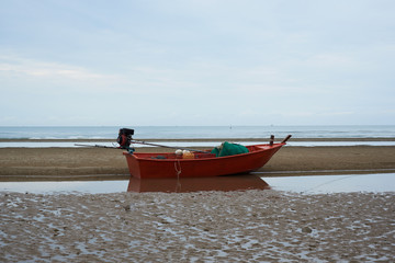 A red fisherman boat on the beach
