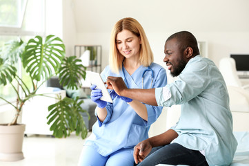 Fototapeta premium African-American man meeting with plastic surgeon in clinic