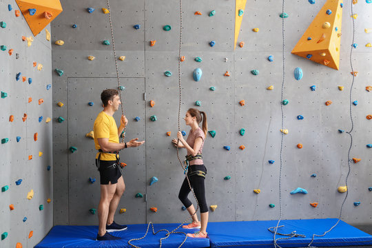 Young man and woman in climbing gym