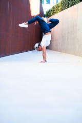 Young woman doing handstand yoga