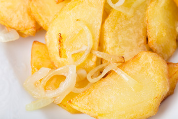 Baked potato wedges with onions and parsley.