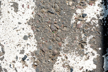 Old dirty asphalt texture with white paint on it. Top view