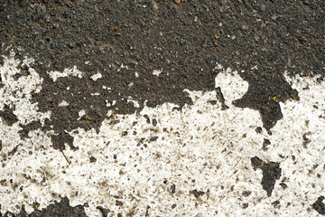 Old dirty asphalt texture with white paint on it. Top view