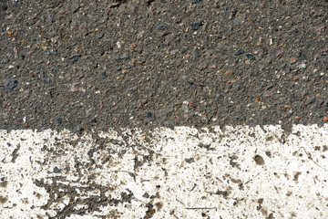 Old dirty asphalt texture with white paint on it. Top view