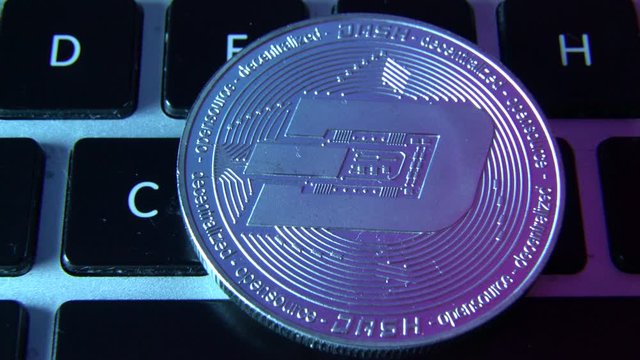 Circle Dash coin on top of computer keyboard buttons. Digital currency, block chain market, online business