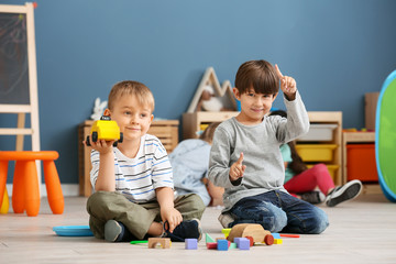 Cute little children playing in kindergarten