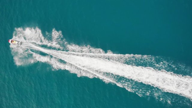 Aerial vertical drone shot of a jet ski cruising on the water. Protaras, Cyprus