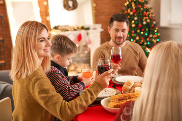 Happy family drinking wine during Christmas dinner at home