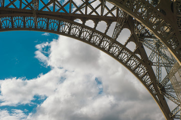 Eiffel tower with blue sky in a cloudy day