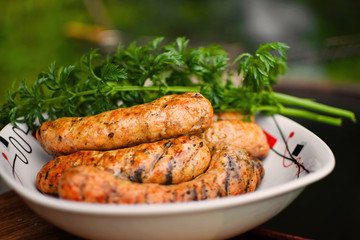Grilled bavarian sausages on a white plate.