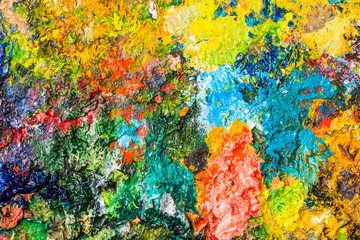 Background image of bright oil-paint palette closeup.