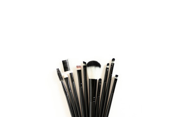 Cosmetic brushes on white background with copy space