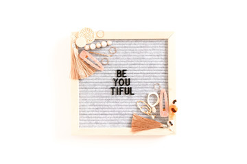 Quote Be You Tiful. Composition with letterboard, earrings, hairpins, rings on white background