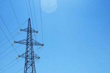 High voltage electrical pole. Electricity pole against blue sky. Transmission line of electricity. Copy space.