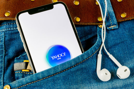 Sankt-Petersburg, Russia, April 14, 2018: Yahoo Mail application icon on Apple iPhone X smartphone screen close-up in jeans pocket. Yahoo mail app icon. Social network. Social media icon