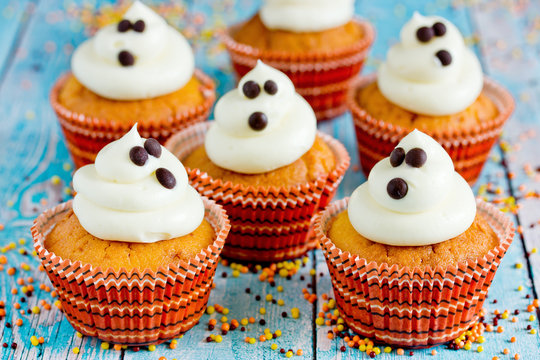 Halloween Ghost Cupcakes , Homemade Sweet Pumpkin Cakes With Cream Cheese Frosting Shaped Funny Ghosts For Kid Treats On Halloween Party