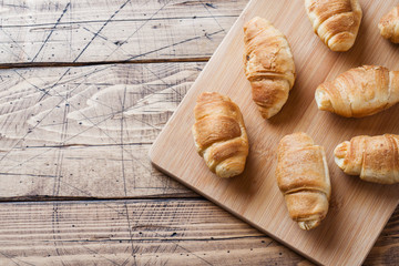 Croissants with chocolate filling on wooden background. Copy space.