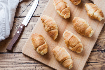Croissants with chocolate filling on wooden background. Copy space.