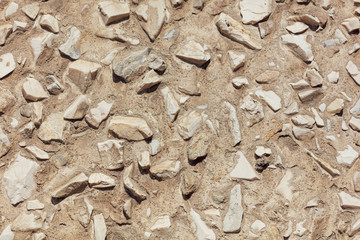 Stone rubble in the concrete wall as background