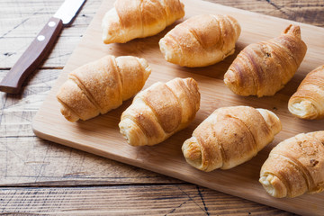 Croissants with chocolate filling on wooden background. Copy space.