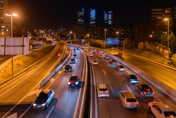 M30 highway at night with Madrid skyline (Four towers business area) as background, Spain