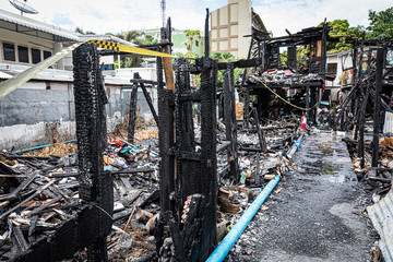 The old wooden house in the slum caused a fire in the ruins.