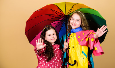 family bonds. Little girls in raincoat. happy little girls with colorful umbrella. rain protection. Rainbow. autumn fashion. cheerful hipster children, sisterhood. No more rain. Snapping memories