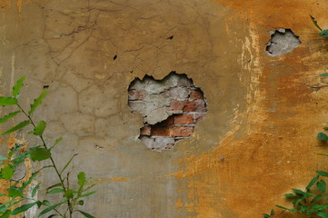 Old brick wall with peeled plaster