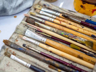 Artist paint brush set. Close-up many artist tools in calico paint brush holder.