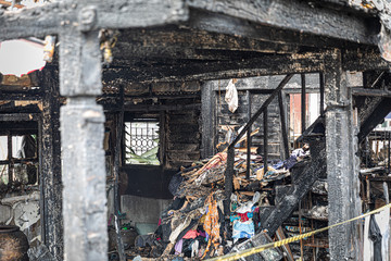 The old wooden house in the slum caused a fire in the ruins.