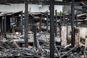 The old wooden house in the slum caused a fire in the ruins.