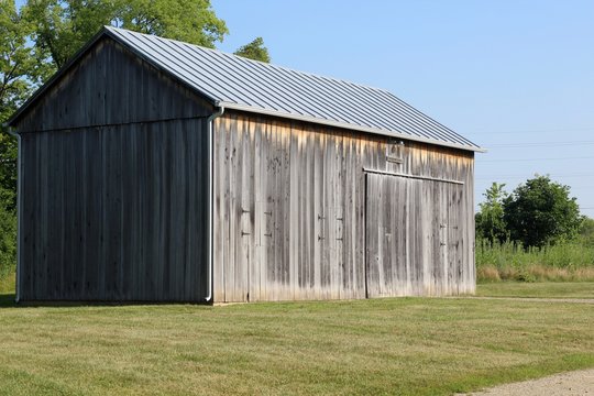 A side view of the old wood barn in the countryside.