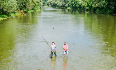 one mission. Big game fishing. male friendship. father and son fishing. adventures. two happy fisherman with fishing rod and net. recreation and leisure outdoor. hobby and sport activity. Trout bait