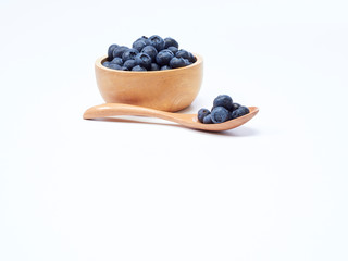 blueberry in wooden bowl on white background