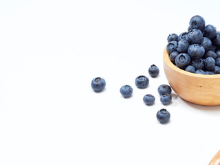 blueberry in wooden bowl on white background