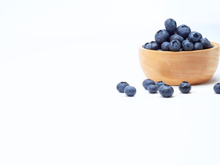blueberry in wooden bowl on white background