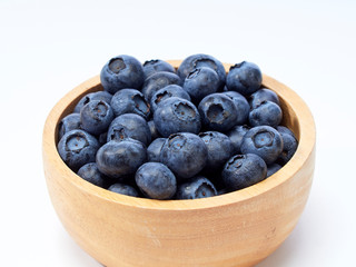 blueberry in wooden bowl on white background