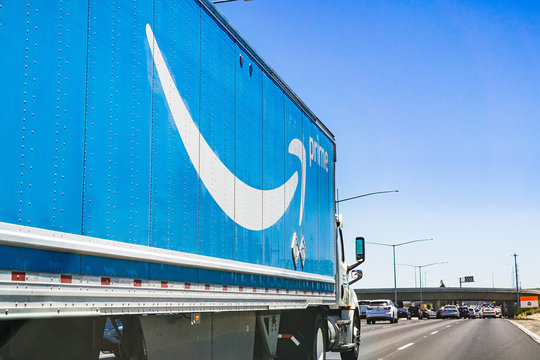 July 13, 2019 Newark / CA / USA - Amazon truck driving on the freeway, the large Prime logo printed on the side; San Francisco bay area